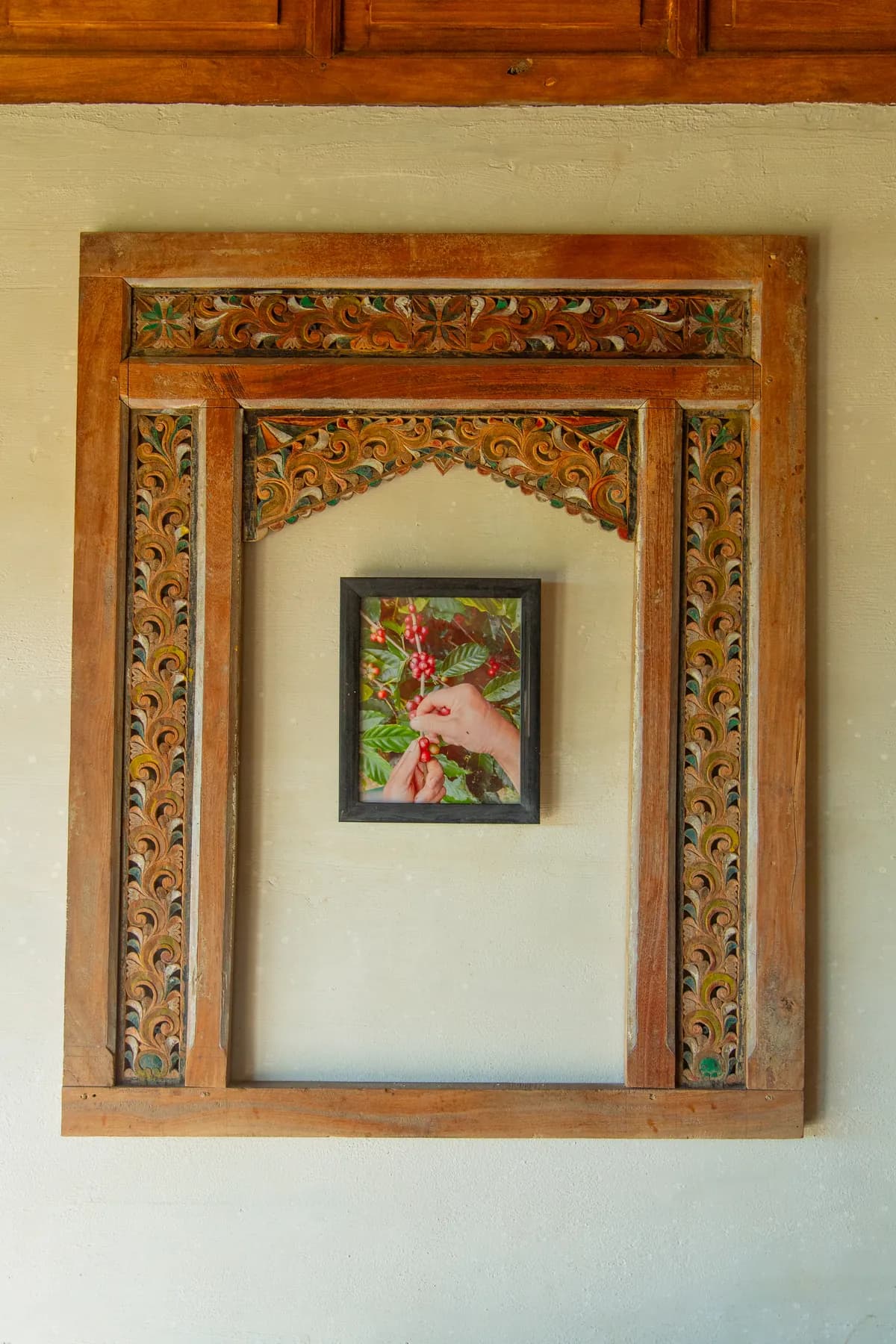 A framed painting on the timber wall