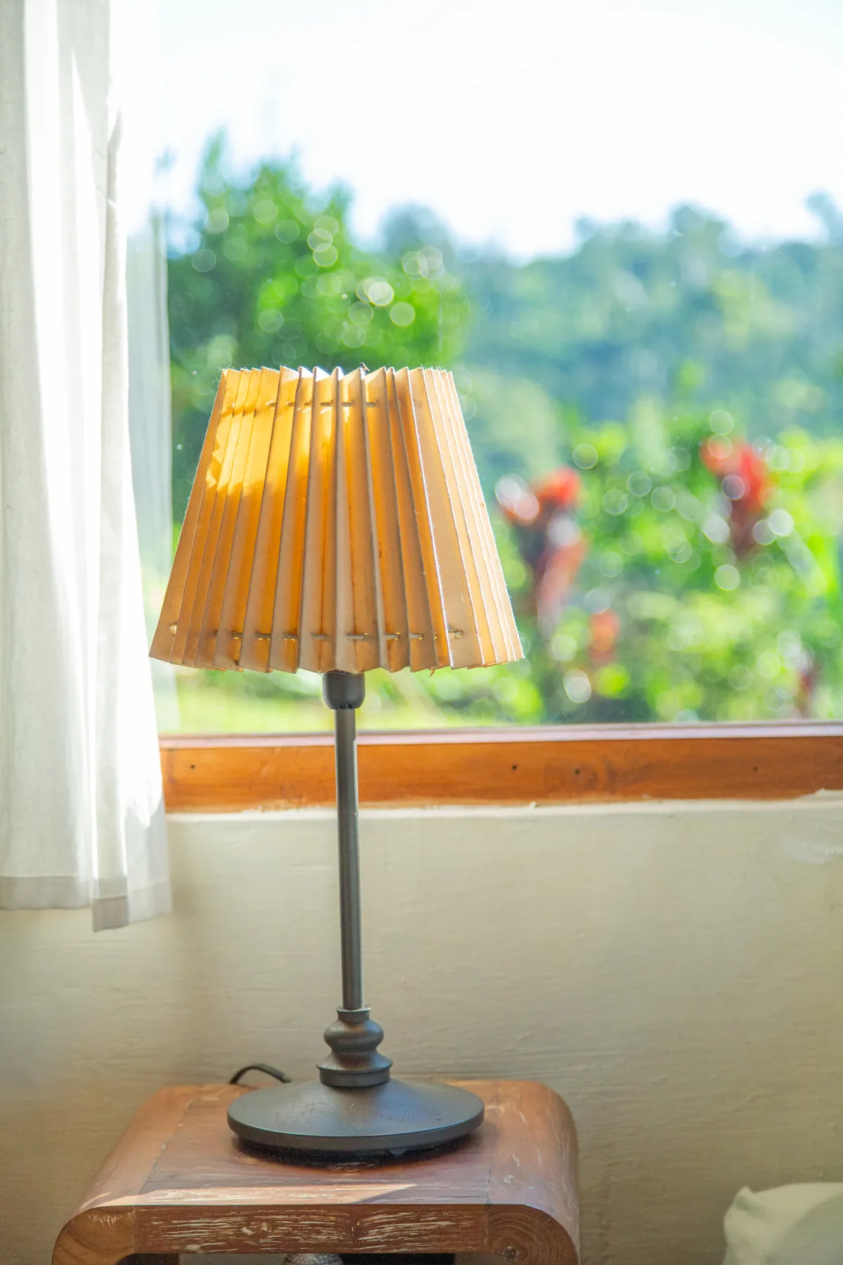 A shaded lamp on the windowsill