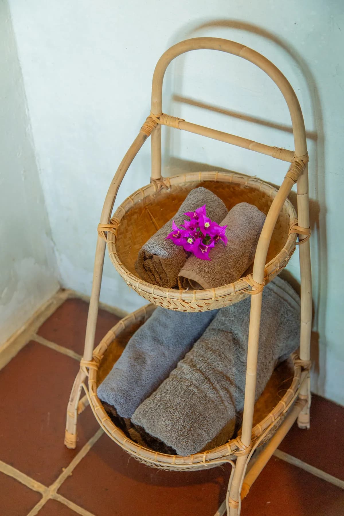 Folded towels on a rattan stand