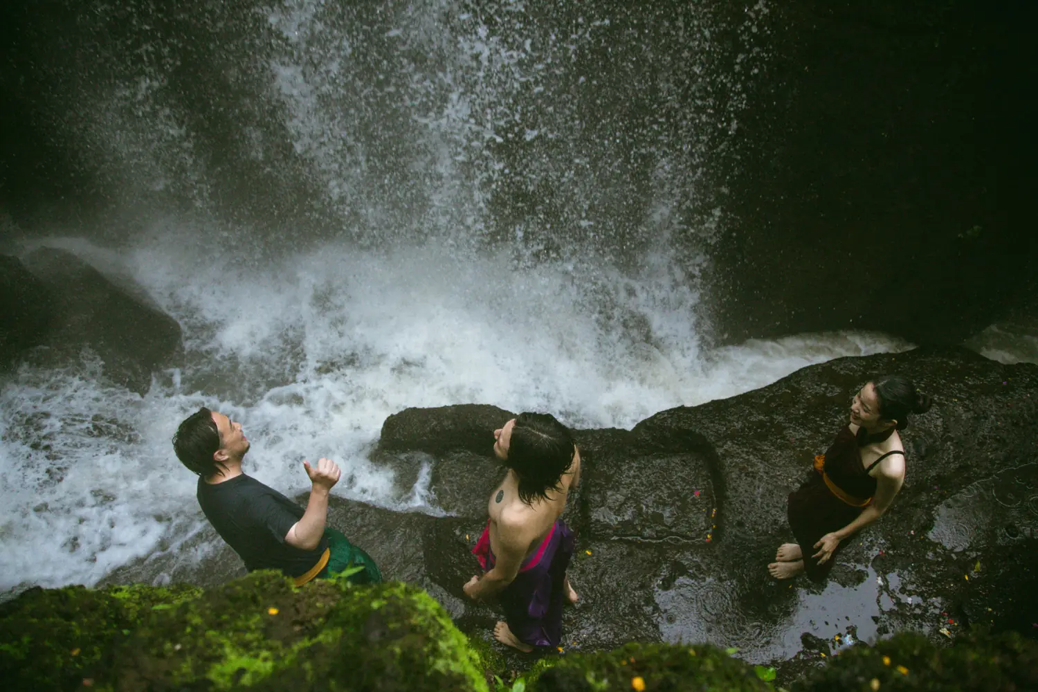 Standing beneath the waterfall during a melukat purification