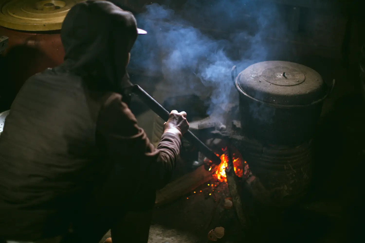 Roasting green coffee in a pan over an open fire