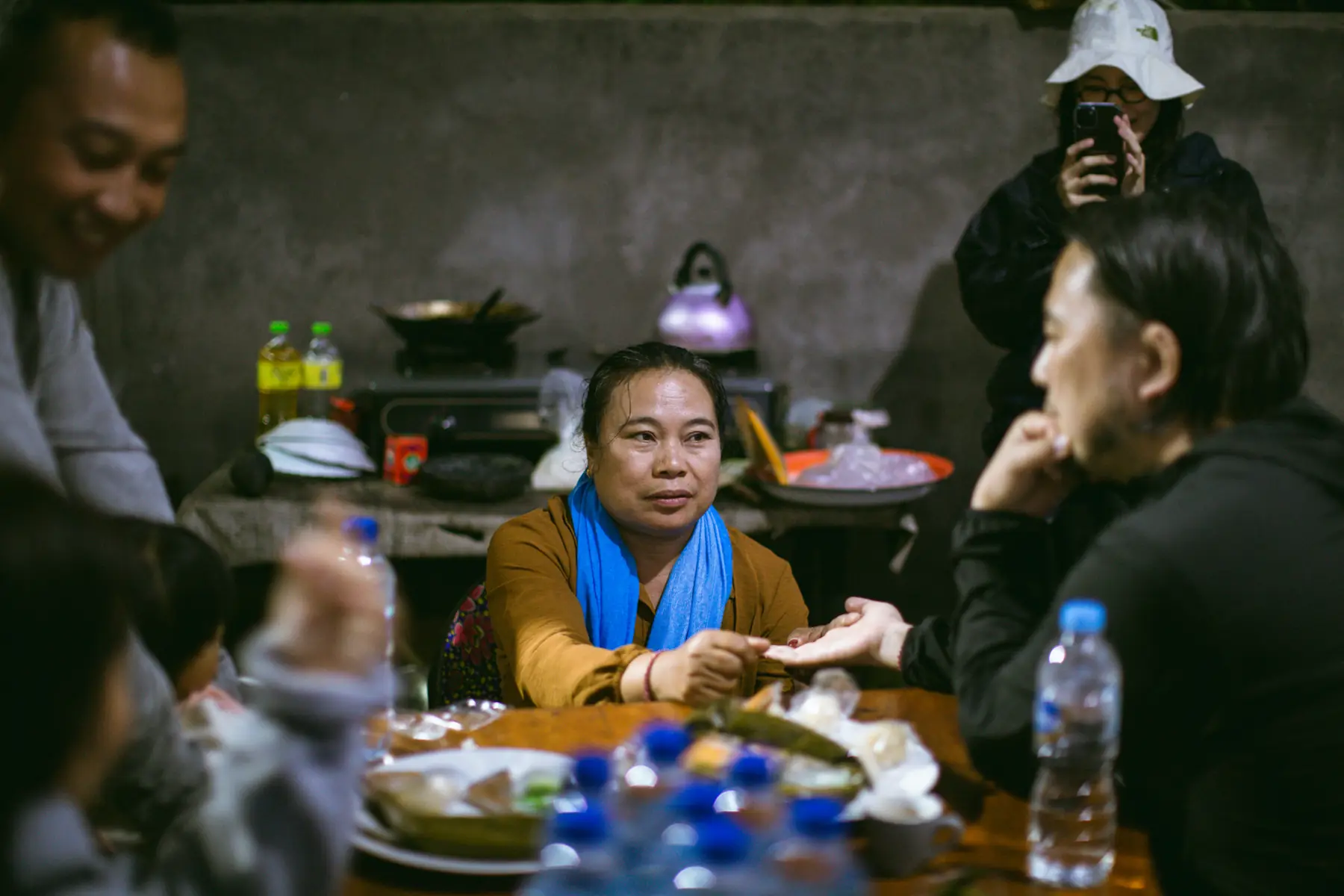 A table of home-cooked dishes with people eating together